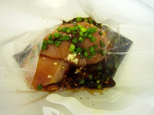 Ingredients with chicken breast in a Ziploc bag