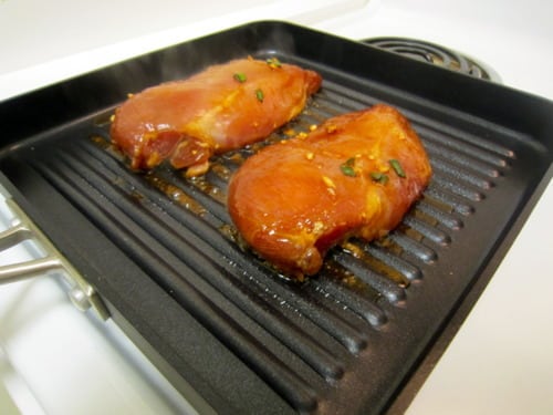 Two chicken breasts on a grill