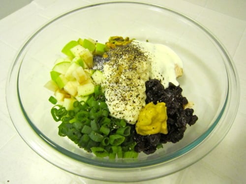 chicken, mayonnaise, yogurt, dijon, green onions, apple, pistachios, dried cherries, poppy seeds, salt and pepper in a glass mixing bowl.