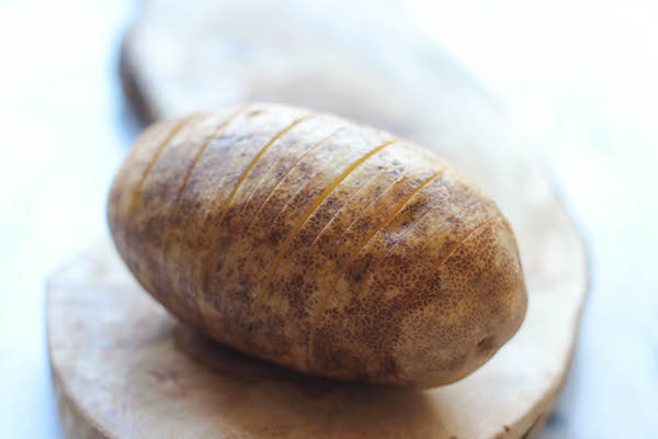 Loaded Hasselback Potatoes - A glorified baked potato loaded with melted cheddar cheese, sour cream, and crisp bacon bits!