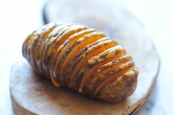 Loaded Hasselback Potatoes - A glorified baked potato loaded with melted cheddar cheese, sour cream, and crisp bacon bits!