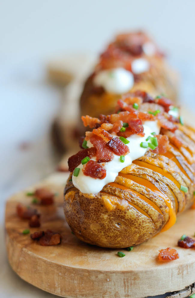 Loaded Hasselback Potatoes - A glorified baked potato loaded with melted cheddar cheese, sour cream, and crisp bacon bits!