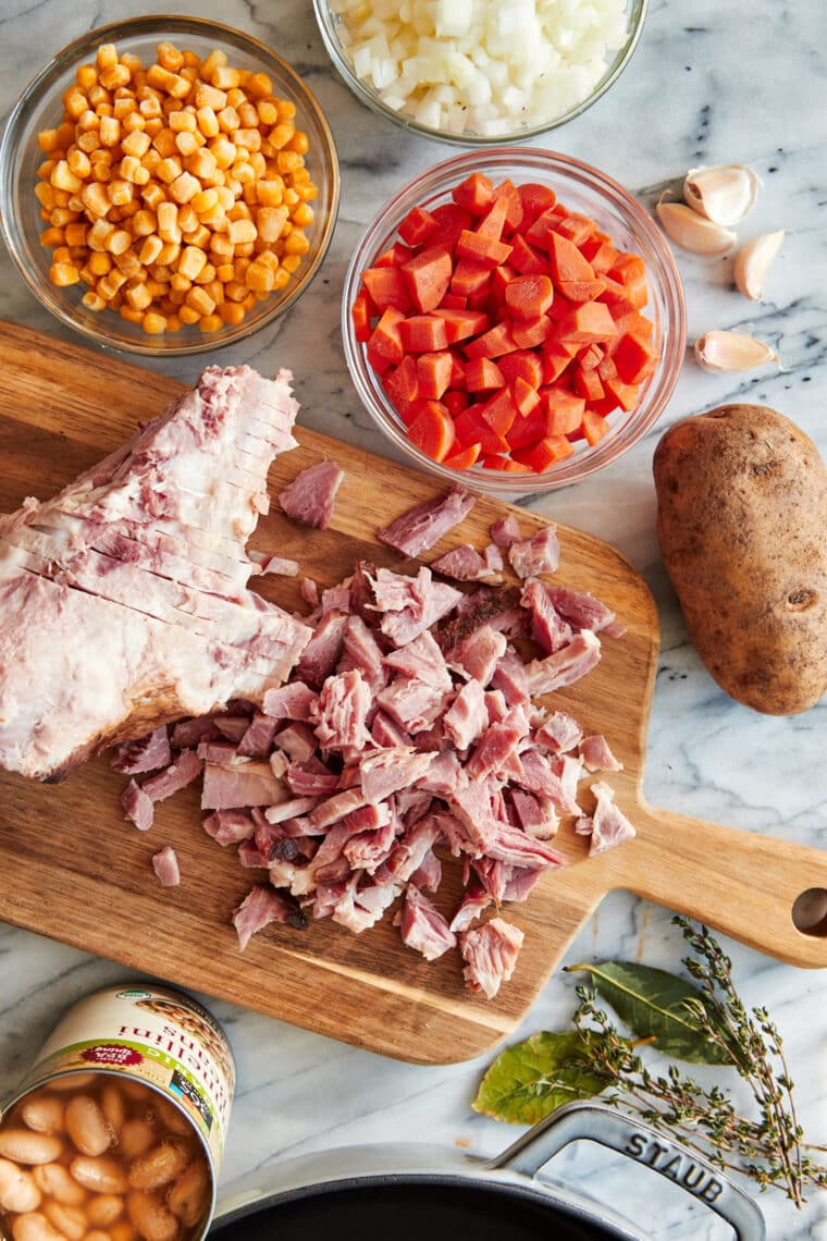 Close-up of ham bone soup with vegetables, beans, and ham chunks