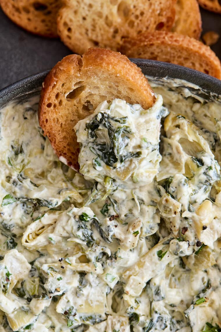 Slow Cooker Spinach and Artichoke Dip - Dump and go, set and forget right into the crockpot for the best and easiest cheesy, creamy dip ever!