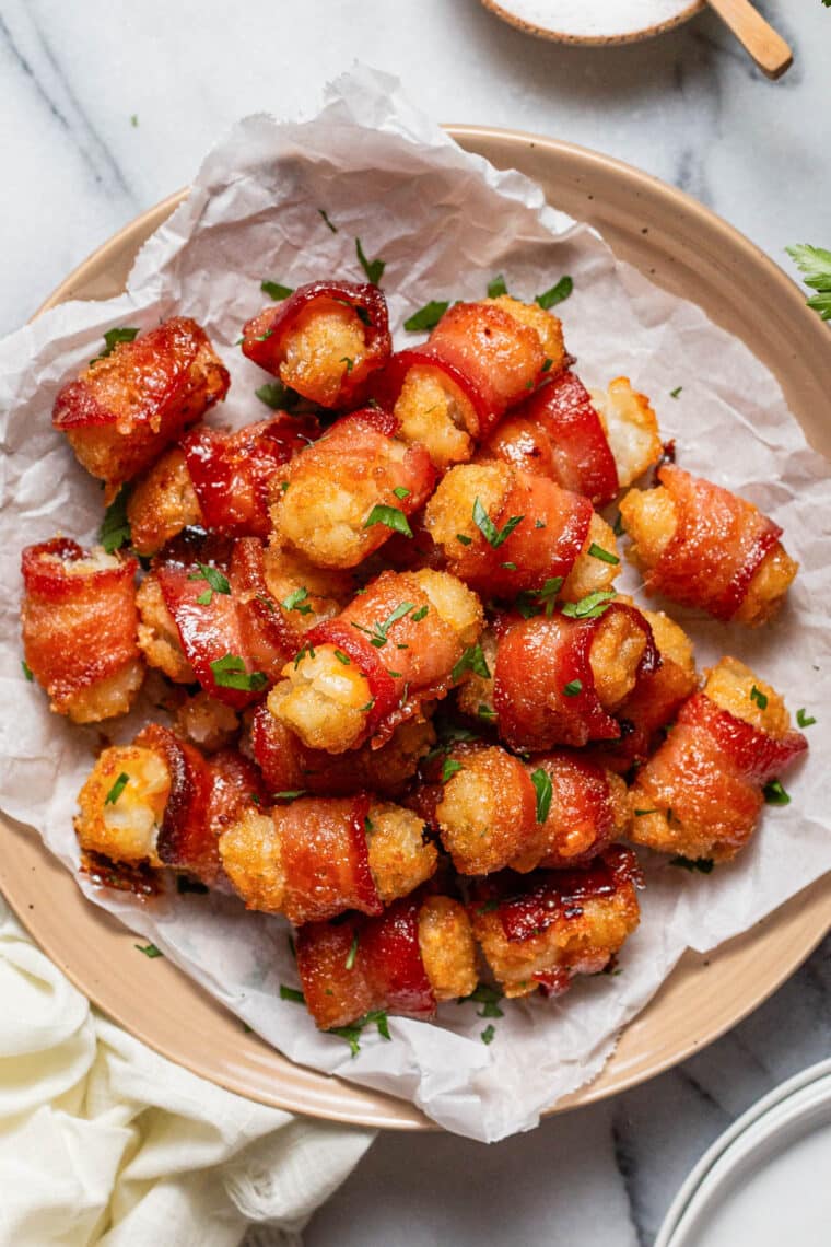 Baked bacon wrapped tater tots on plate