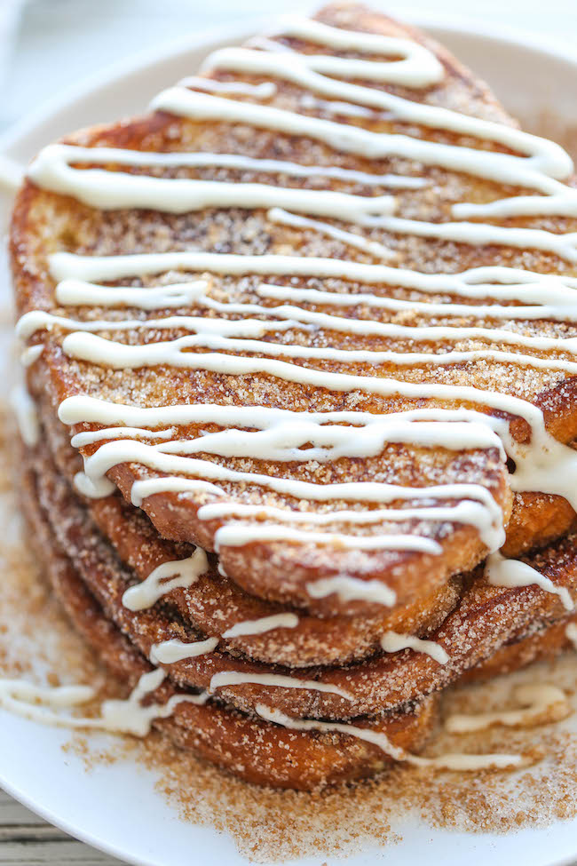 Churro French Toast - The most amazing, most buttery French toast you will ever have, coated in cinnamon sugar and drizzled with an epic cream cheese glaze!