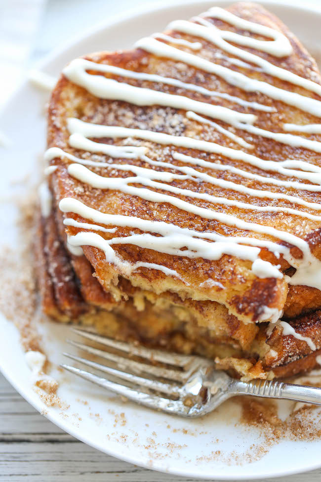 Churro French Toast - The most amazing, most buttery French toast you will ever have, coated in cinnamon sugar and drizzled with an epic cream cheese glaze!