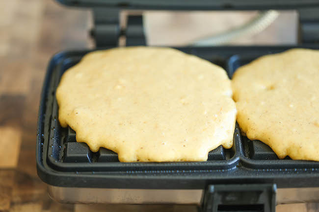 Pumpkin Churro Waffles - Light, fluffy, melt-in-your mouth pumpkin waffles coated in buttery cinnamon sugar and drizzled with a cream cheese glaze! Amazing.