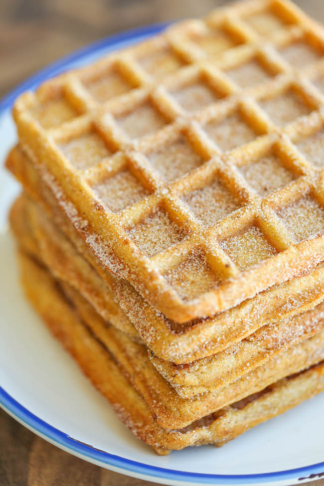 Pumpkin Churro Waffles - Light, fluffy, melt-in-your mouth pumpkin waffles coated in buttery cinnamon sugar and drizzled with a cream cheese glaze! Amazing.