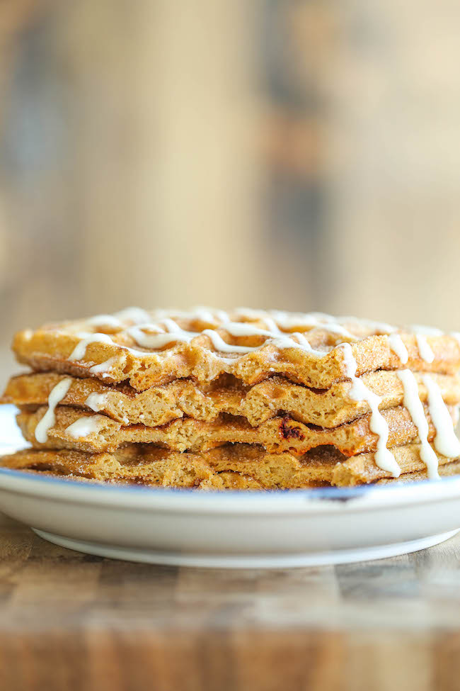 Pumpkin Churro Waffles - Light, fluffy, melt-in-your mouth pumpkin waffles coated in buttery cinnamon sugar and drizzled with a cream cheese glaze! Amazing.
