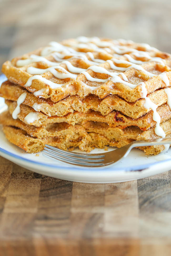 Pumpkin Churro Waffles - Light, fluffy, melt-in-your mouth pumpkin waffles coated in buttery cinnamon sugar and drizzled with a cream cheese glaze! Amazing.