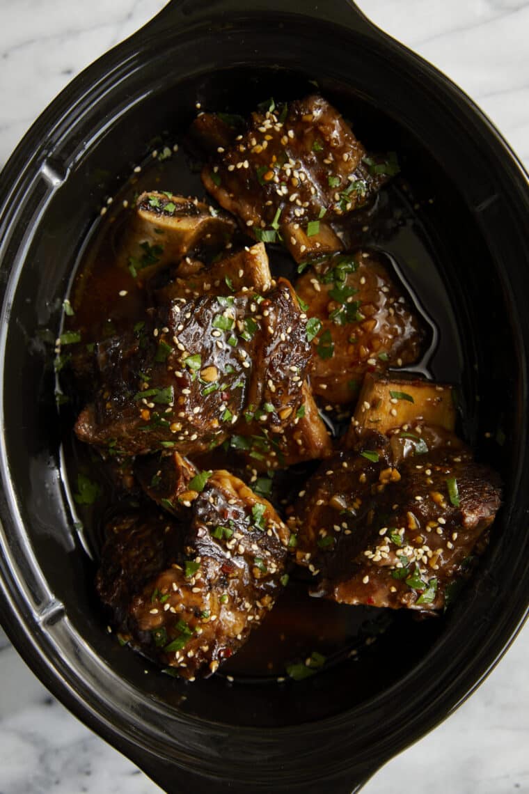 Slow Cooker Asian Short Ribs - Literally fall-off-the-bone tender! SO SO GOOD. Set and forget right in your crockpot. So easy with zero fuss!