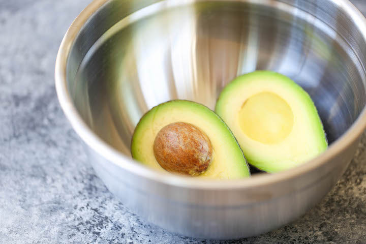 Southwestern Egg Rolls with Cilantro Avocado Sauce - Loaded with avocado, corn, beans and tomatoes! And you'll never guess that it's completely baked!