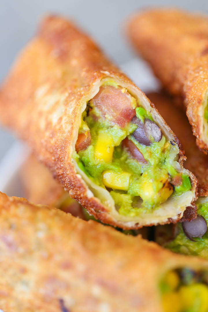 Southwestern Egg Rolls with Cilantro Avocado Sauce - Loaded with avocado, corn, beans and tomatoes! And you'll never guess that it's completely baked!