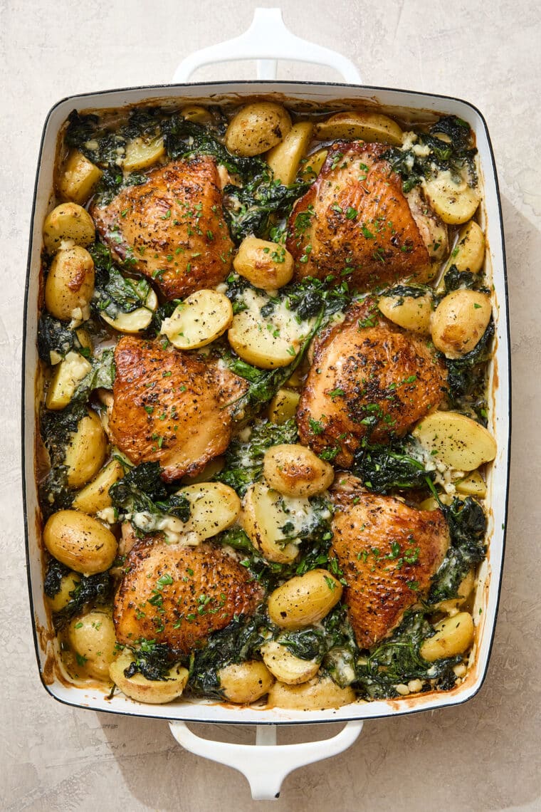 Chicken and Potatoes with Garlic Parmesan Cream Sauce - A complete meal in one! Baked crisp-tender chicken with potatoes and spinach, so good!