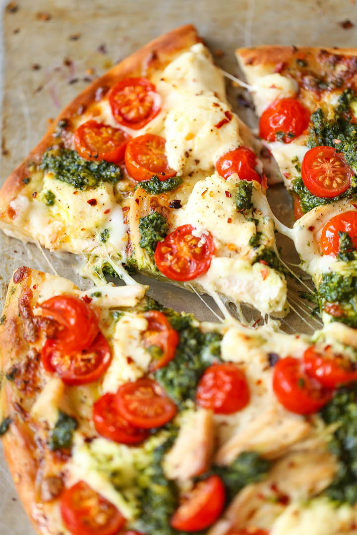 Chicken Pesto Pizza - The absolute perfect weeknight meal that comes together in minutes! Use leftover rotisserie chicken, fresh tomatoes, pesto and cheese!