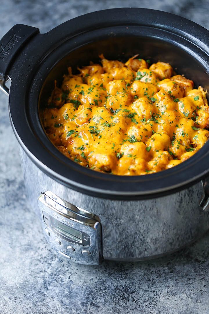 Slow Cooker Tater Tot Casserole - An absolute crowd-pleaser! Loaded with ground beef, cheese and everyone's fave: TATER TOTS! Made in the crockpot! EASY!!!
