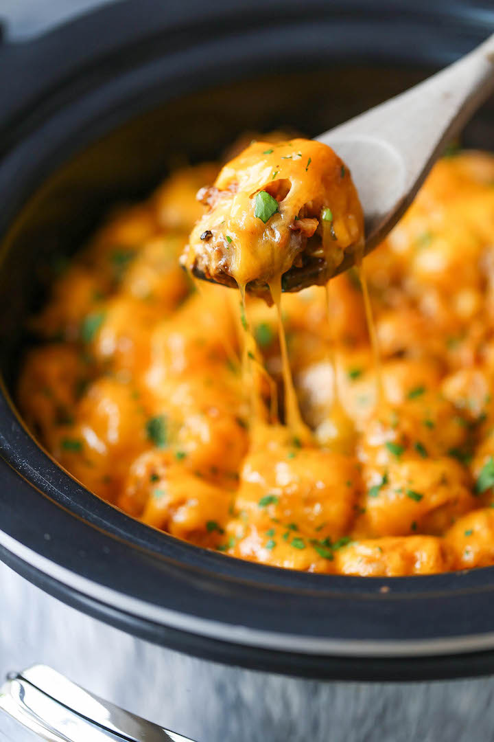 Slow Cooker Tater Tot Casserole - An absolute crowd-pleaser! Loaded with ground beef, cheese and everyone's fave: TATER TOTS! Made in the crockpot! EASY!!!