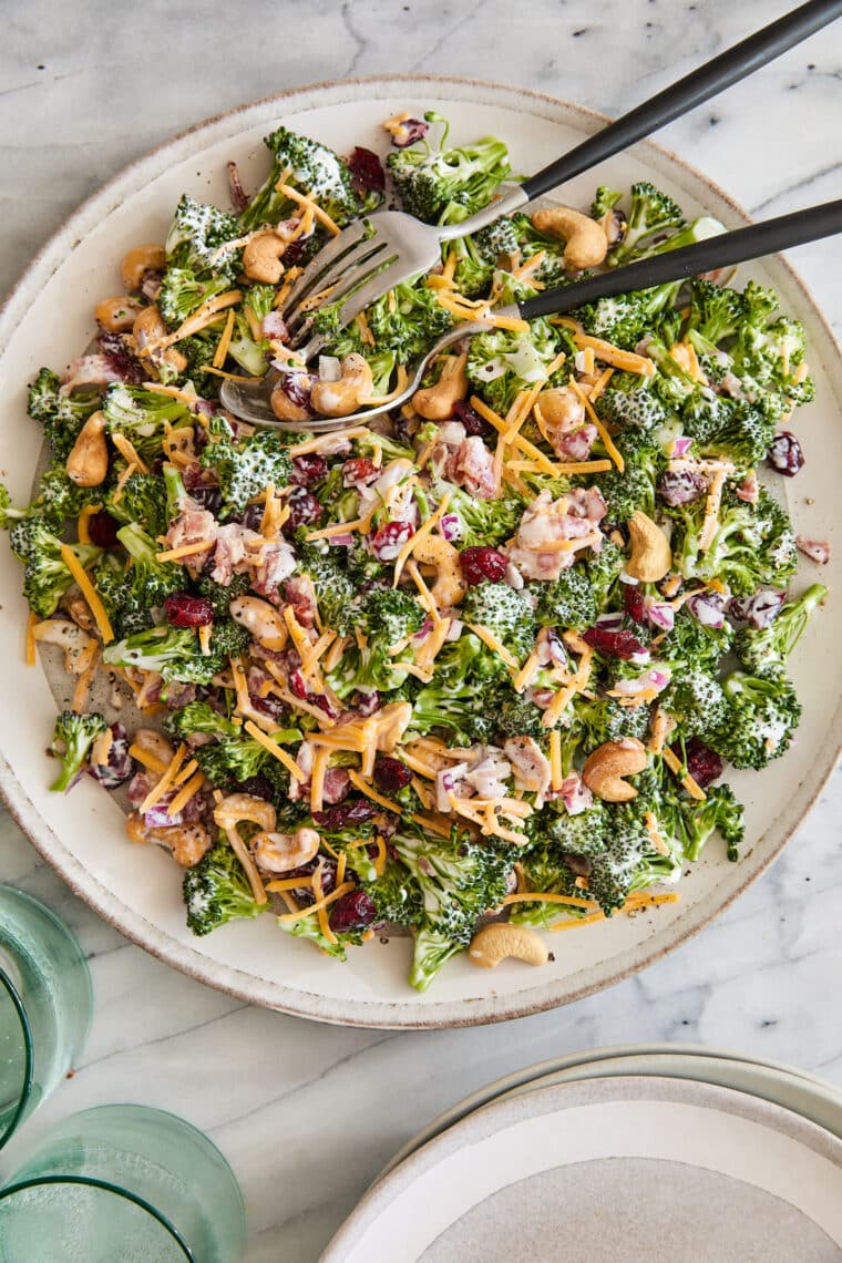 Creamy Broccoli Salad - Seriously the BEST broccoli salad ever! With cheese, cashews, red onion, crispy bacon + the creamiest dressing ever!