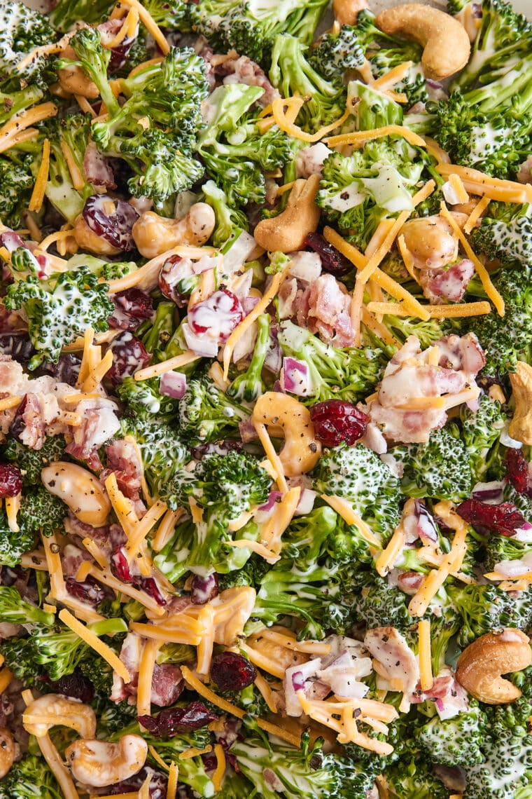 Creamy Broccoli Salad - Seriously the BEST broccoli salad ever! With cheese, cashews, red onion, crispy bacon + the creamiest dressing ever!