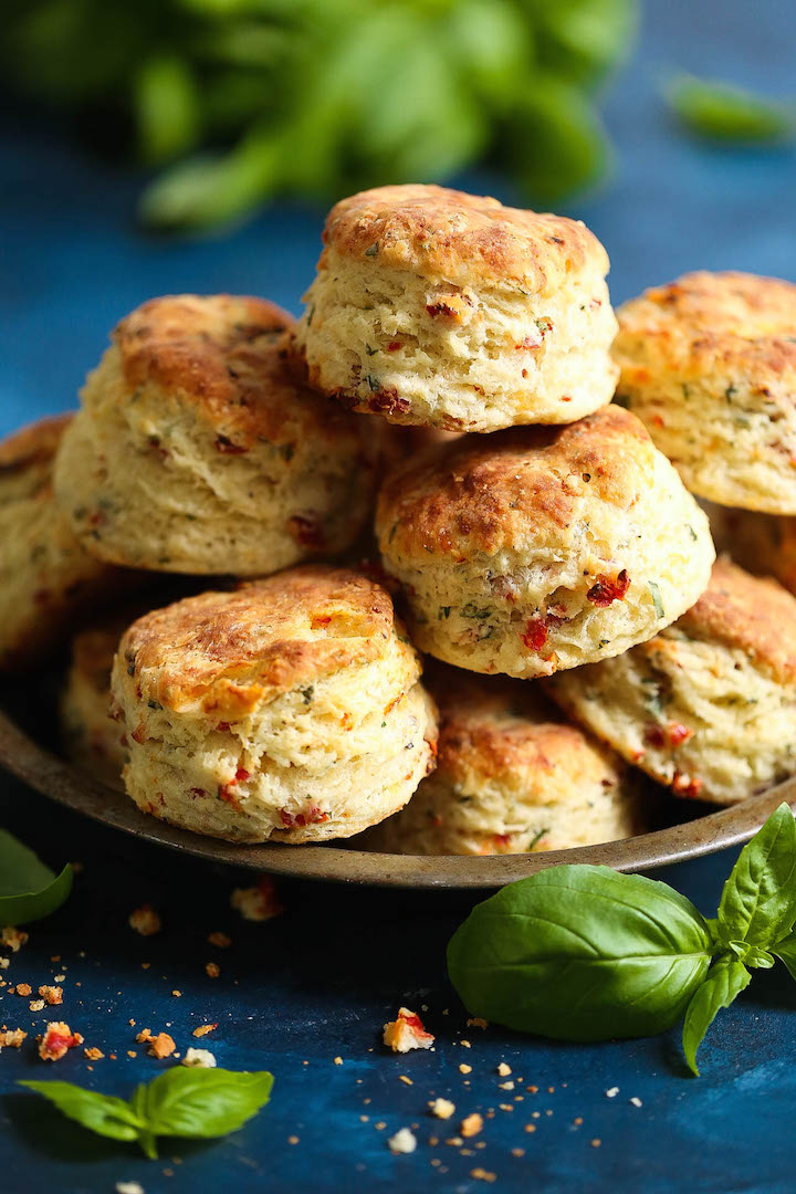 Sun Dried Tomato Parmesan Biscuits - These savory biscuits are simply irresistible! Warm, flaky, buttery and packed with so much flavor from the sun dried tomatoes, fresh basil, and Parmesan cheese. Just try to stop at one of these!