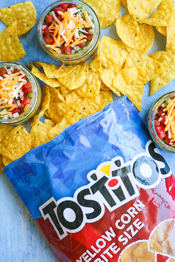 5-Layer Mason Jar Taco Dip - Everyone’s favorite dip in mason jar form! Everything is layered in individual jars so it makes for the easiest serving! Loaded with taco beef, refried beans, guacamole, pico de gallo, and cheese!