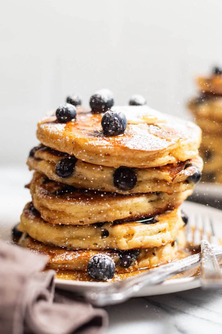 Blueberry Sour Cream Pancakes - Light, fluffy, melt-in-your-mouth buttery pancakes with juicy blueberries. Restaurant-quality right at home!