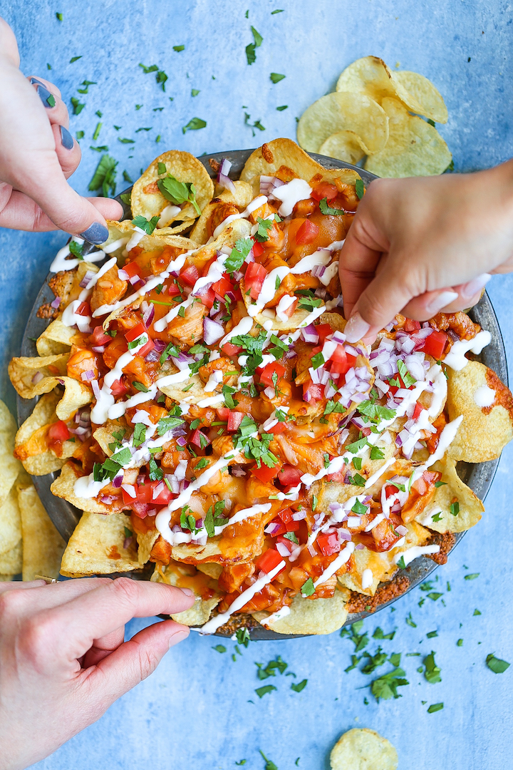 Loaded BBQ Chicken Nachos - Say hello to the best nachos EVER! Loaded with perfectly tender BBQ chicken bites, two types of cheeses, tomatoes, onion, sour cream, cilantro and potato chips! Guaranteed to be a crowd-pleaser. I PROMISE!