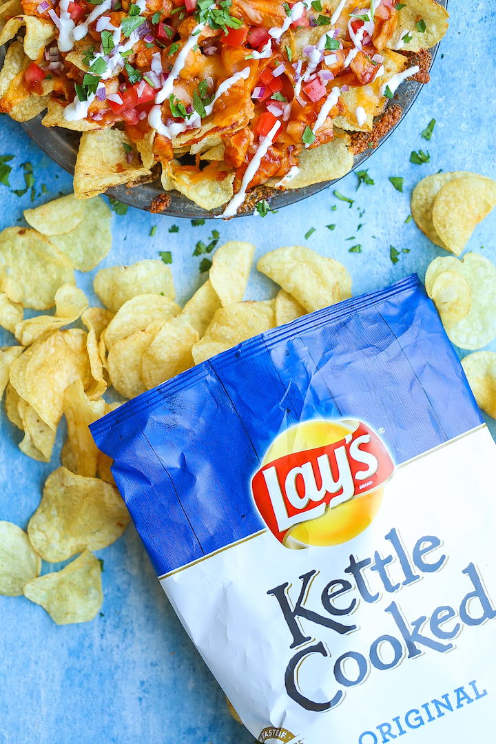 Loaded BBQ Chicken Nachos - Say hello to the best nachos EVER! Loaded with perfectly tender BBQ chicken bites, two types of cheeses, tomatoes, onion, sour cream, cilantro and potato chips! Guaranteed to be a crowd-pleaser. I PROMISE!