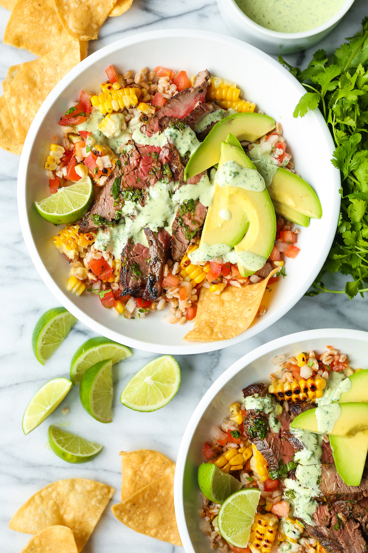 Carne Asada Burrito Bowls - Pico, corn, avocado, cilantro, lime wedges and the best carne asada EVER. Drizzled with cilantro lime vinaigrette. SO SO BOMB.