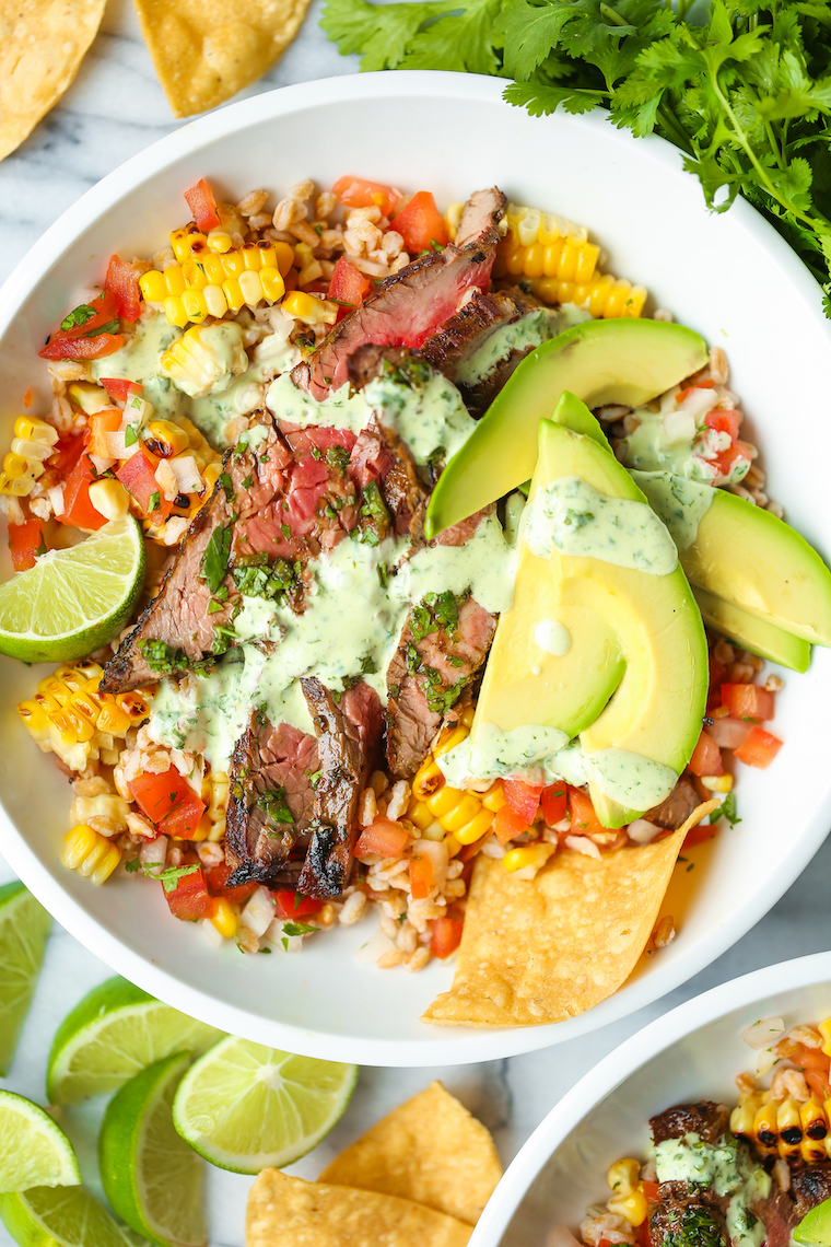 Carne Asada Burrito Bowls - Pico, corn, avocado, cilantro, lime wedges and the best carne asada EVER. Drizzled with cilantro lime vinaigrette. SO SO BOMB.