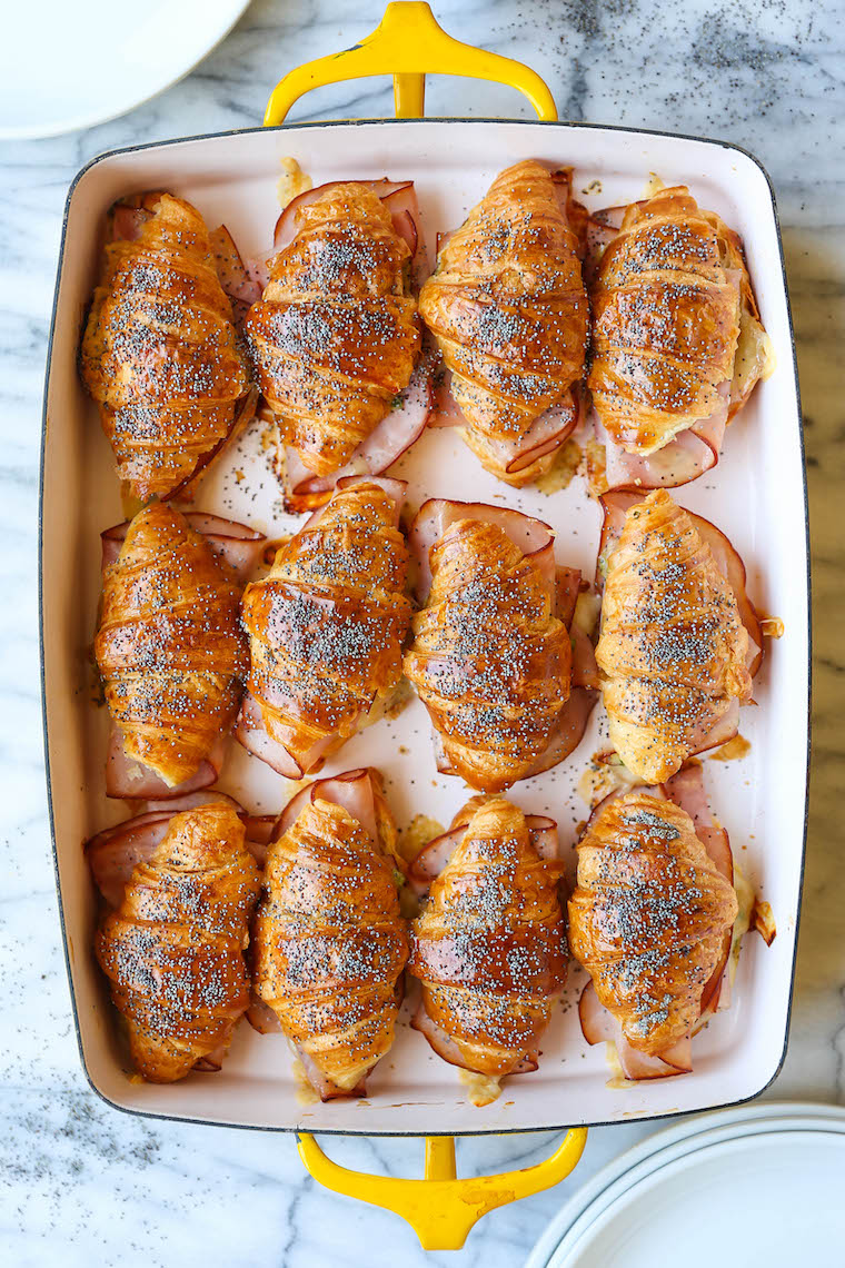 Baked Ham and Cheese Croissants - So so easy to make for a crowd! The mini croissants are toasted and flaky, baked with Dijon-honey, buttery goodness. WHOA.