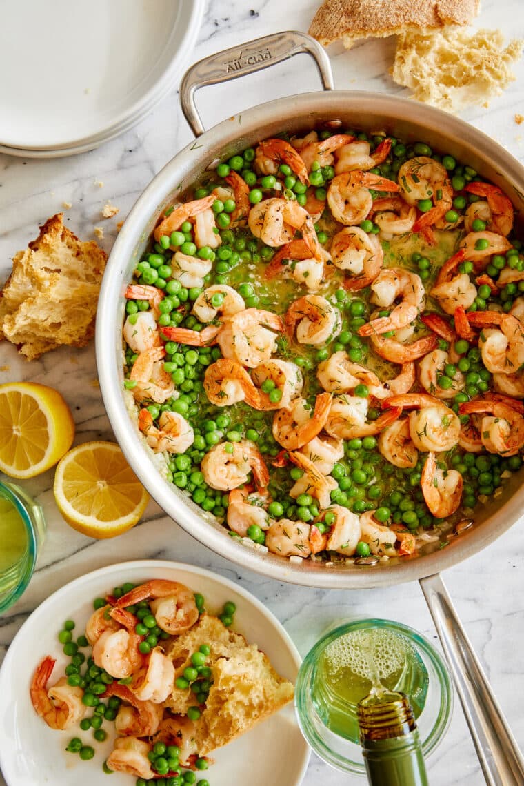 Garlic Shrimp and Peas - Juicy, tender shrimp swimming in a pool of garlicky, buttery goodness. Serve with crusty bread or pasta. SO SO GOOD!