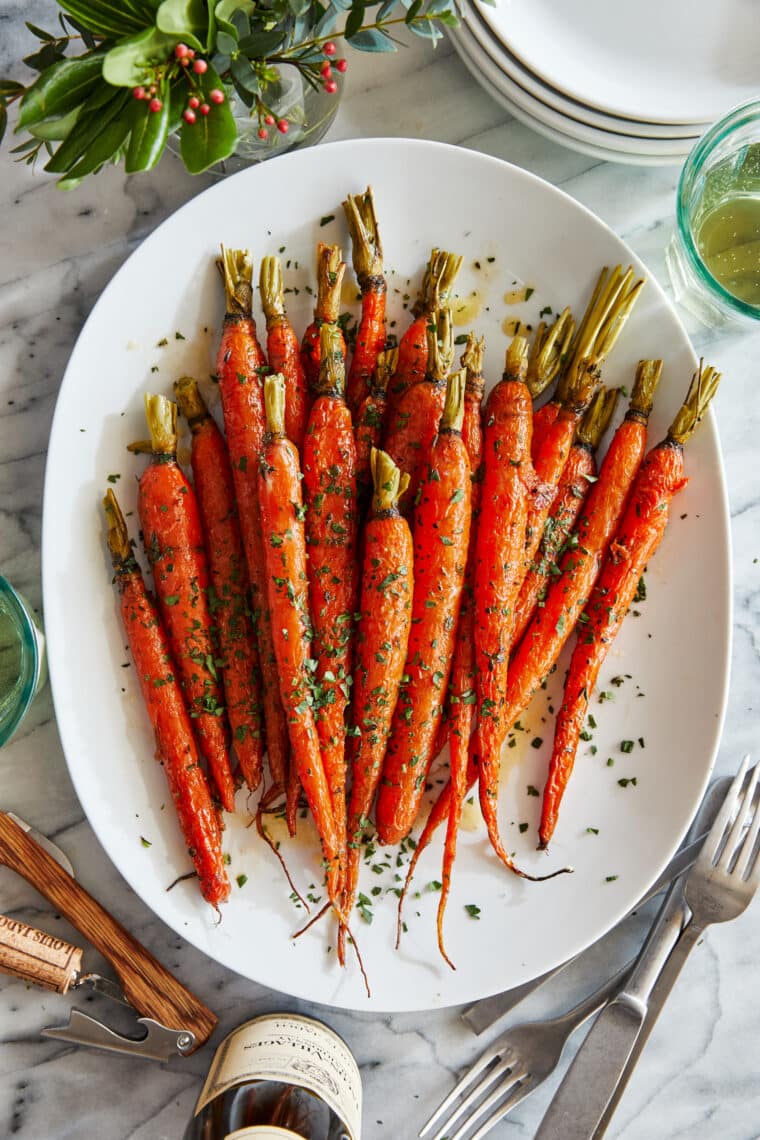 Glazed Carrots - Honey glazed carrots roasted to perfection, tossed in butter + fresh herbs. The easiest (and tastiest) side dish to any meal!