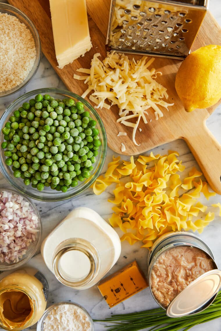 Mixing tuna, noodles, peas, and cheddar cheese for tuna casserole
