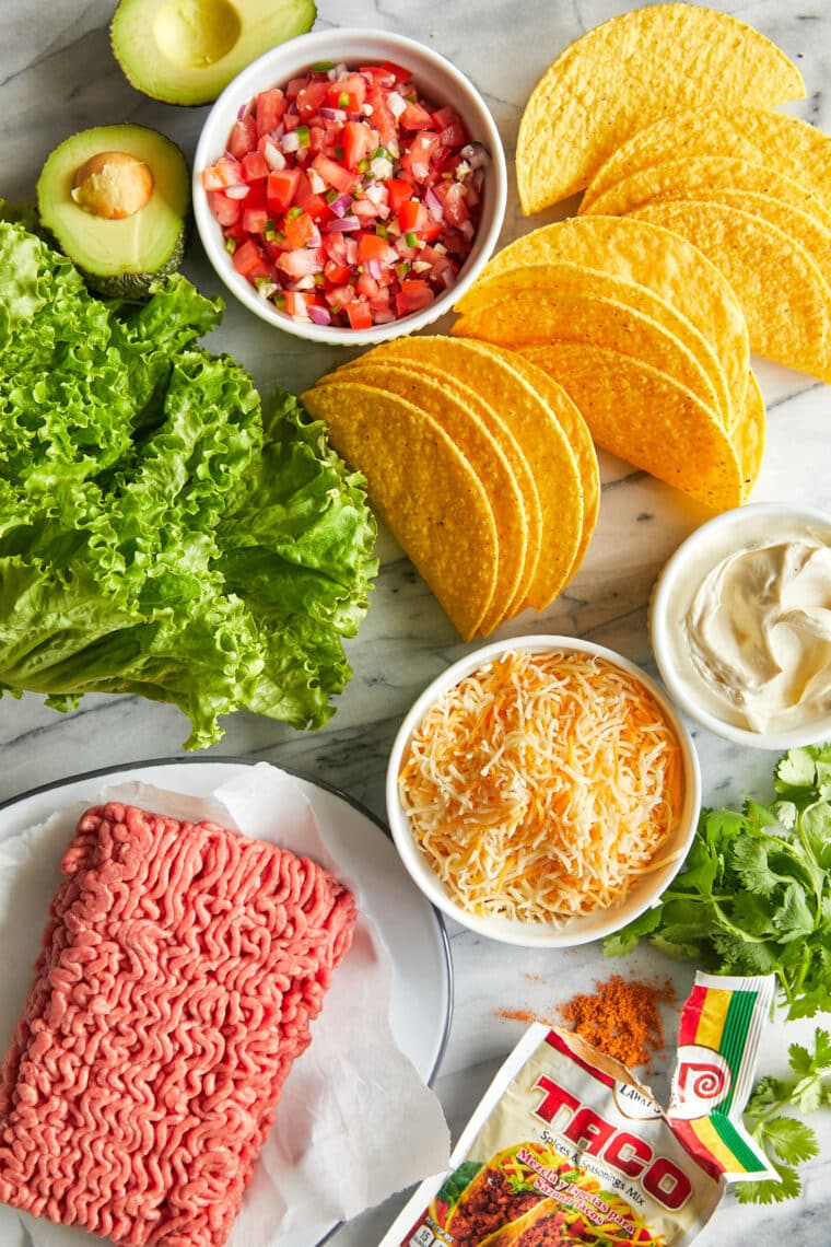 Baked Tacos - Crispy oven baked tacos! Made with hard taco shells, ground beef, taco seasoning, cheese, pico de gallo, sour cream + avocado!