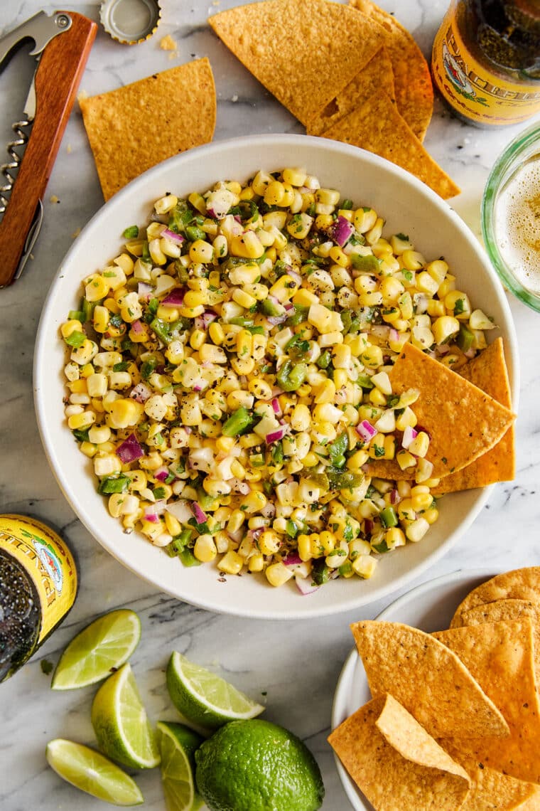 Corn Salsa - Oh so easy, fresh, homemade corn salsa! Made in minutes, perfect with chips or topped on burrito bowls, tacos + quesadillas!!!