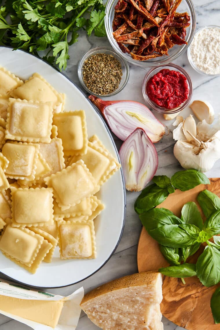 Pillow-y ravioli with the dreamiest, most velvety sun dried tomato cream sauce! A 30-minute weeknight dinner yet fancy enough for company!