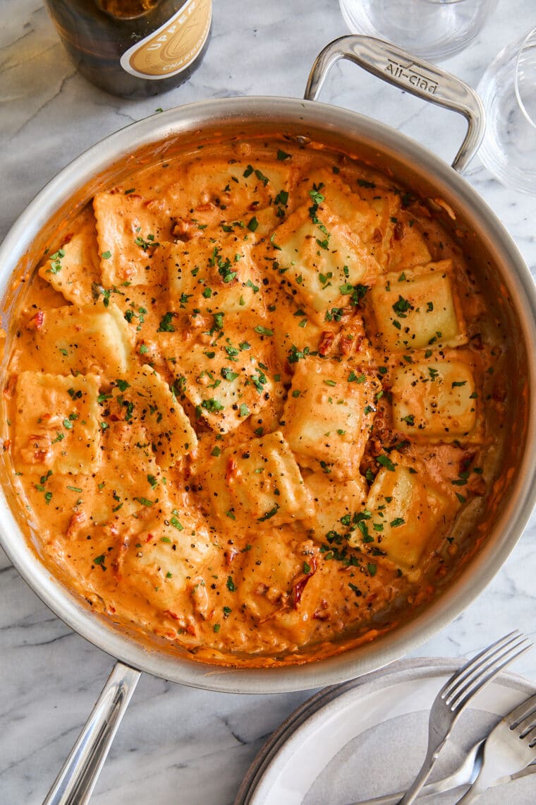 Pillow-y ravioli with the dreamiest, most velvety sun dried tomato cream sauce! A 30-minute weeknight dinner yet fancy enough for company!