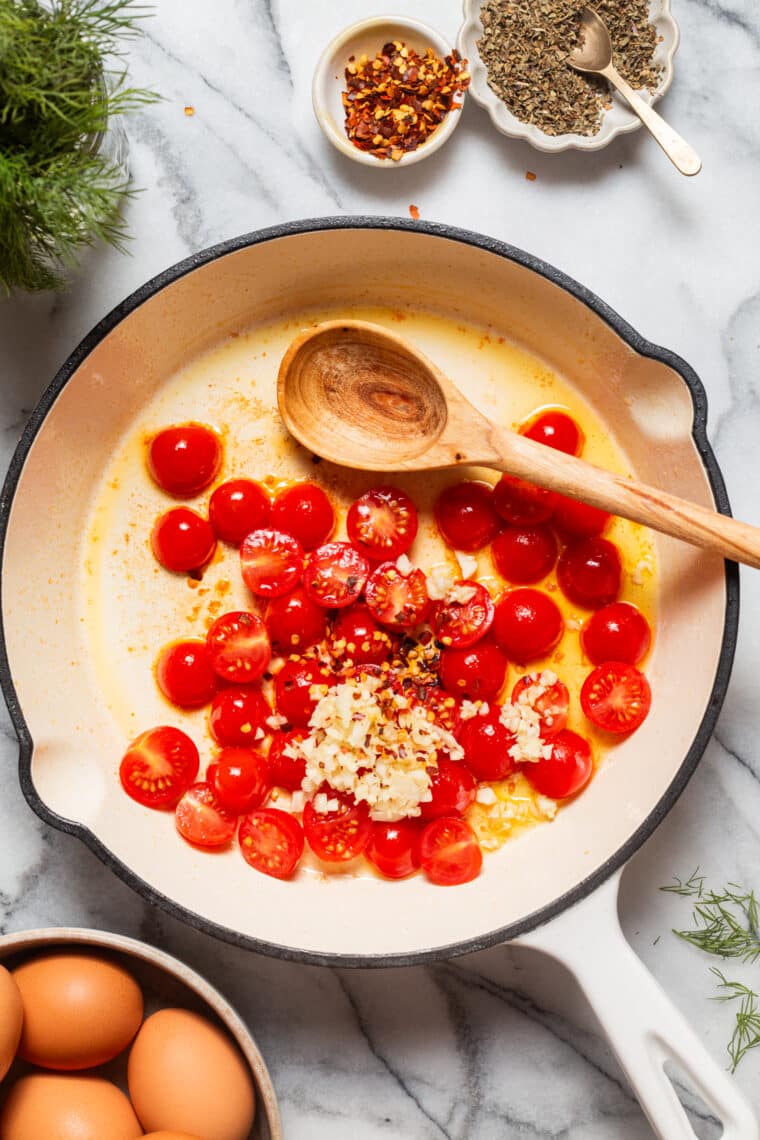 Eggs in Purgatory - An easy, rustic, one pan dish with eggs poached in a rich, savory, garlicky tomato sauce. Best served with all the crusty bread for dunking!